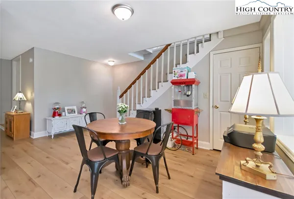 a dining room with furniture and wooden floor