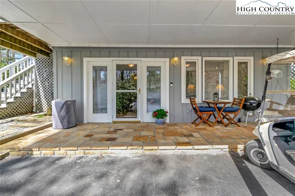 a view of a livingroom with furniture and floor to ceiling window