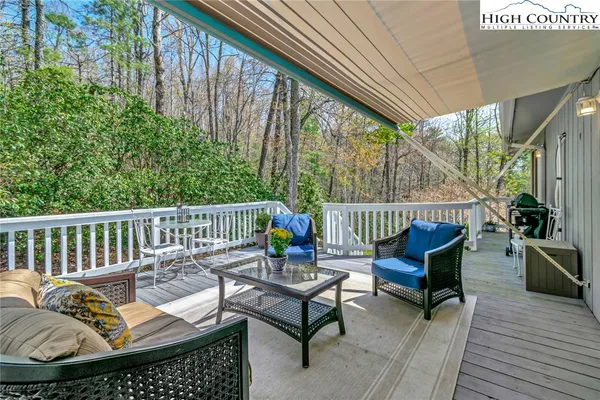 a balcony with furniture and wooden floor