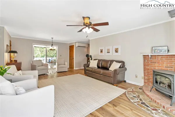 a living room with furniture a fireplace and a window