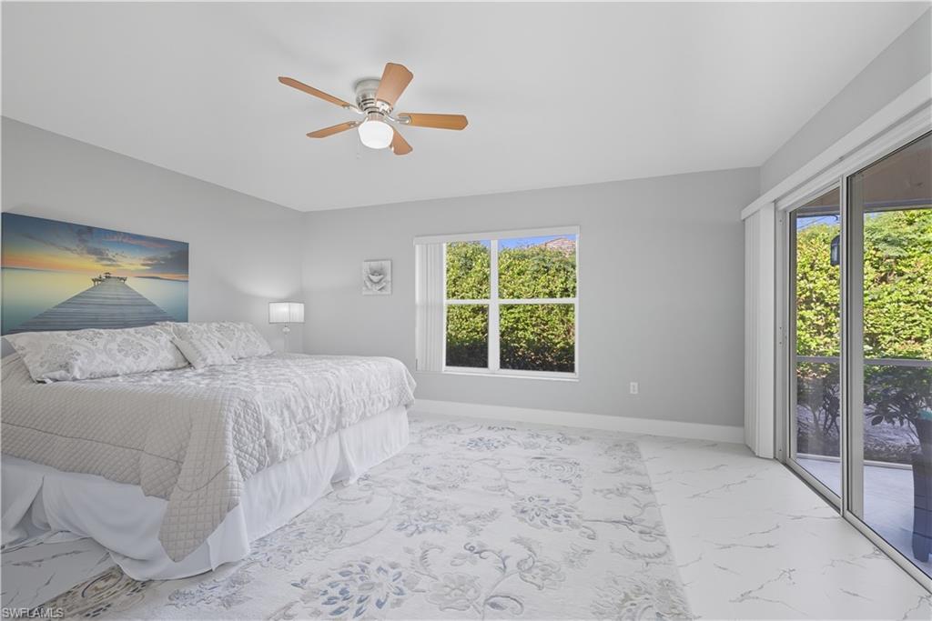 3605 Corinthian Way Naples, FL 34105 - Photo 11 of 34 a bedroom with a large bed and a window