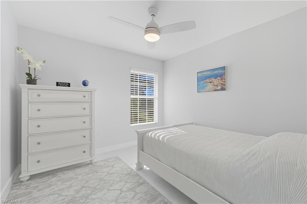 3605 Corinthian Way Naples, FL 34105 - Photo 16 of 34 a bedroom with a bed and a cabinets