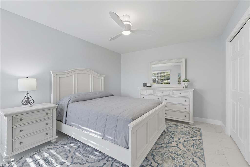 3605 Corinthian Way Naples, FL 34105 - Photo 18 of 34 a bedroom with a bed and a dresser