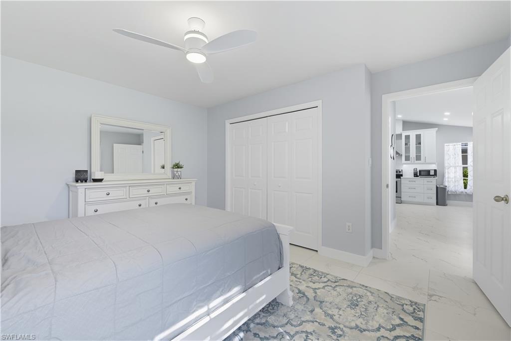 3605 Corinthian Way Naples, FL 34105 - Photo 19 of 34 a bedroom with a bed and a view of bathroom