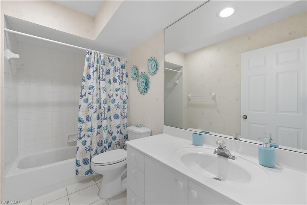 3605 Corinthian Way Naples, FL 34105 - Photo 20 of 34 a bathroom with a sink a toilet and shower