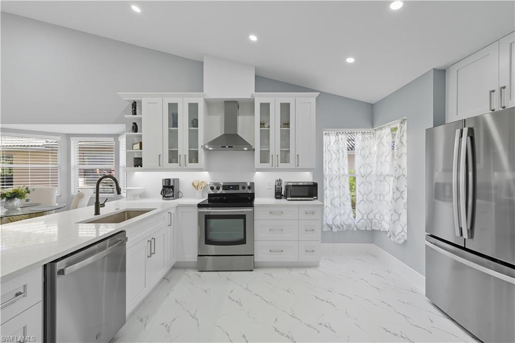 3605 Corinthian Way Naples, FL 34105 - Photo 2 of 34 a kitchen with stainless steel appliances granite countertop a refrigerator sink and stove