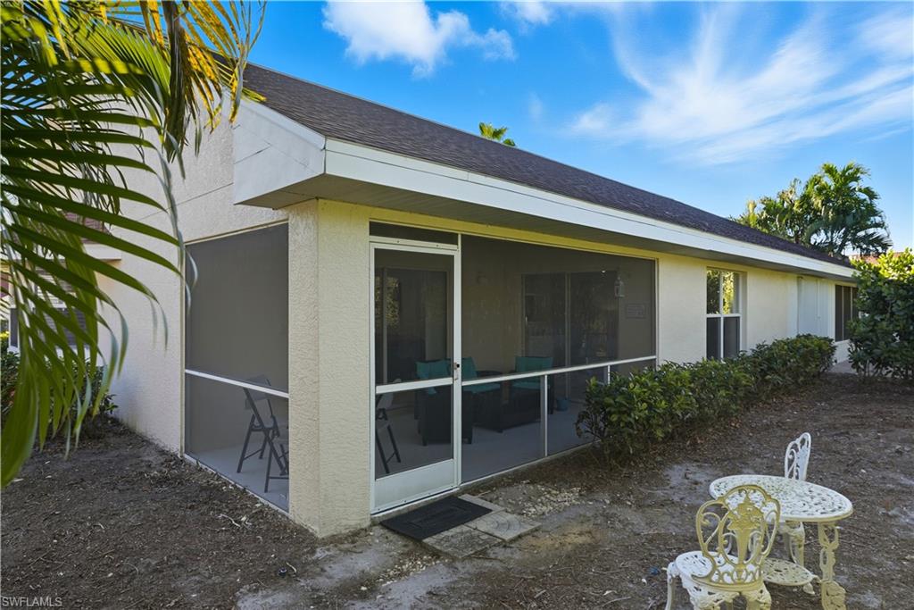 3605 Corinthian Way Naples, FL 34105 - Photo 25 of 34 a backyard of a house with table and chairs