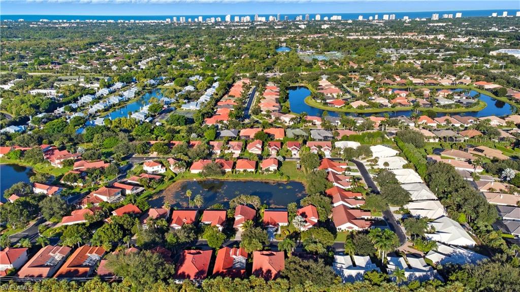 3605 Corinthian Way Naples, FL 34105 - Photo 26 of 34 an aerial view of residential houses with outdoor space and trees