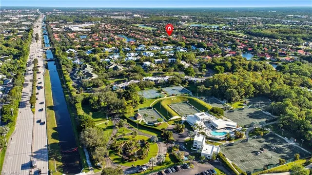 an aerial view of a residential houses with outdoor space and street view