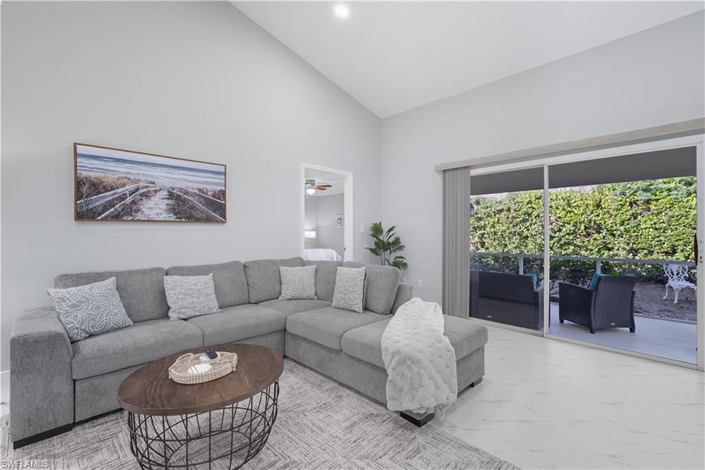 3605 Corinthian Way Naples, FL 34105 - Photo 5 of 34 a living room with furniture and a large window
