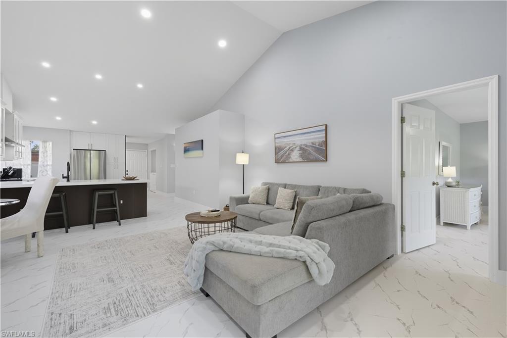 3605 Corinthian Way Naples, FL 34105 - Photo 6 of 34 a living room with furniture and a view of kitchen