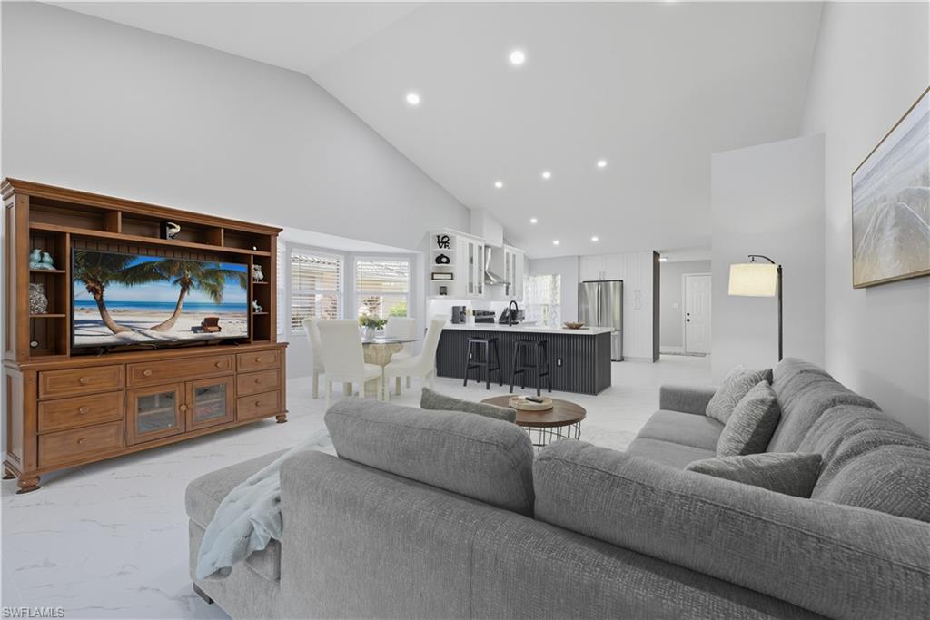 3605 Corinthian Way Naples, FL 34105 - Photo 7 of 34 a living room with furniture and a flat screen tv