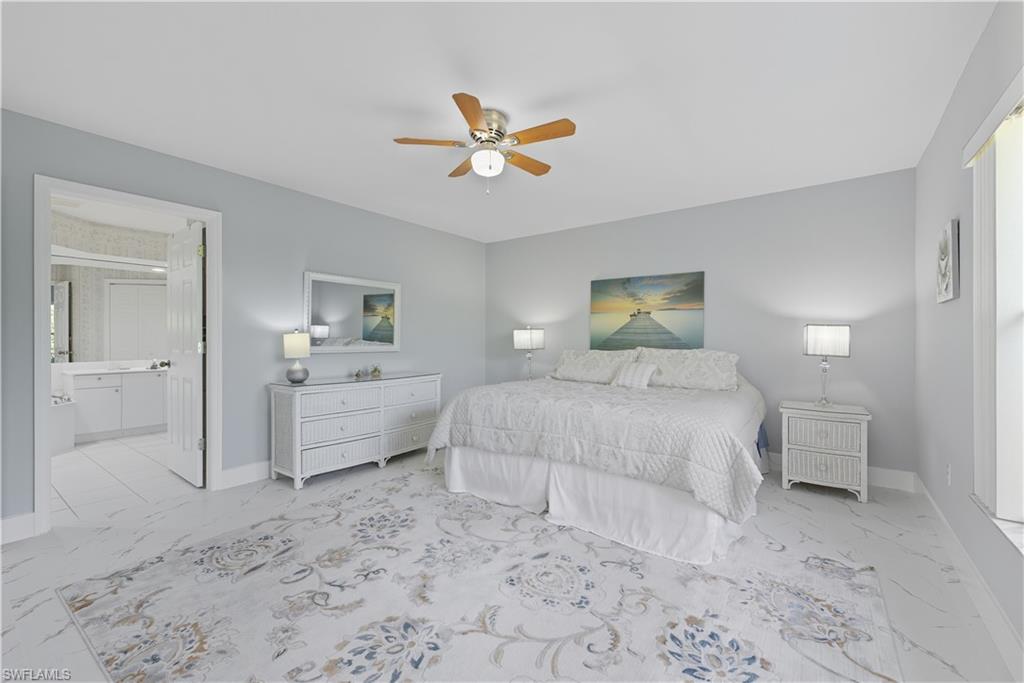 3605 Corinthian Way Naples, FL 34105 - Photo 10 of 34 a bedroom with a bed and a view of bathroom