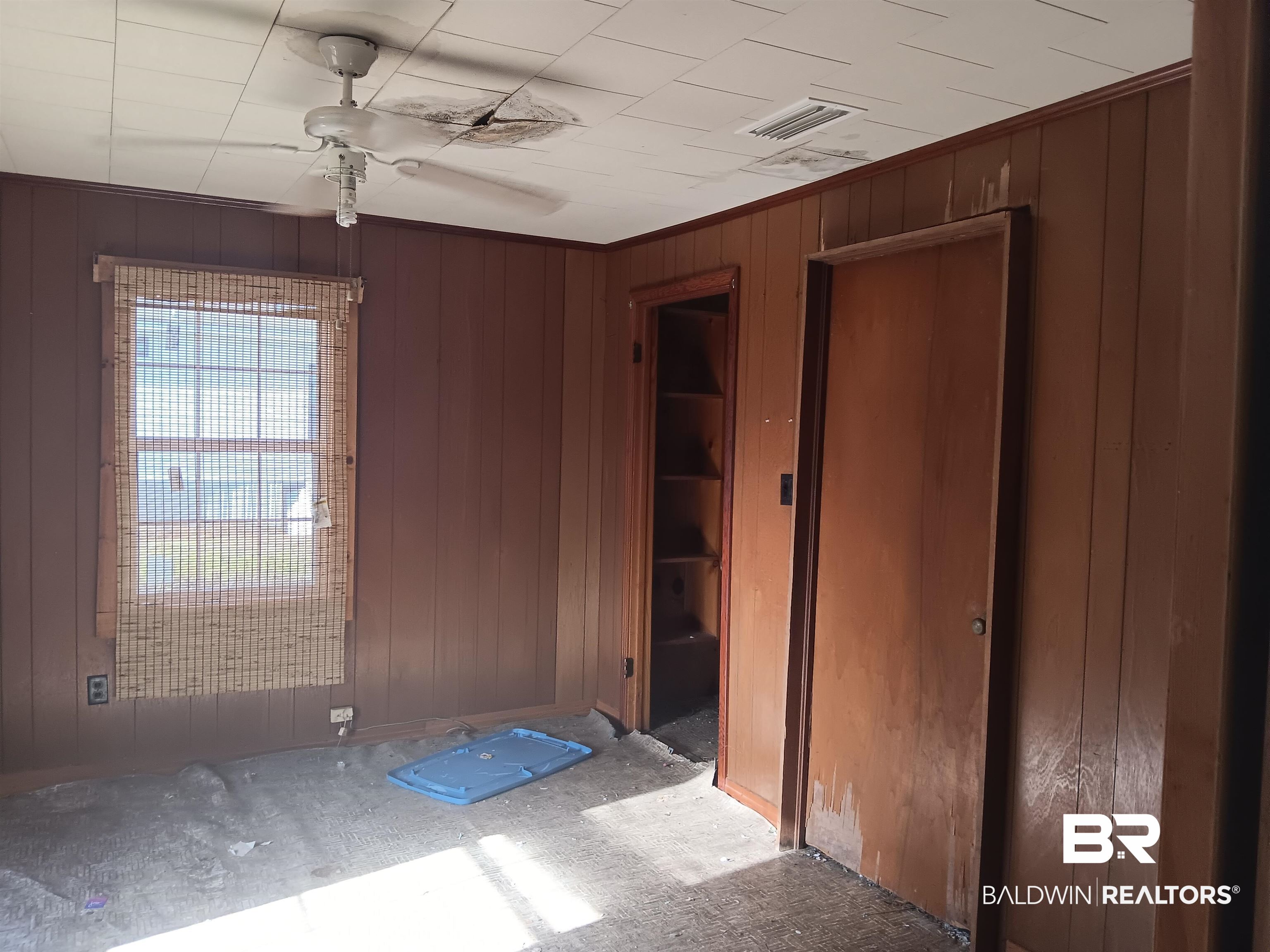 61 Katherine Street Flomaton, AL 36441 - Photo 7 of 13 Empty room featuring wood walls and ceiling fan