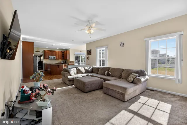 a bathroom with a sink a toilet a mirror and a window