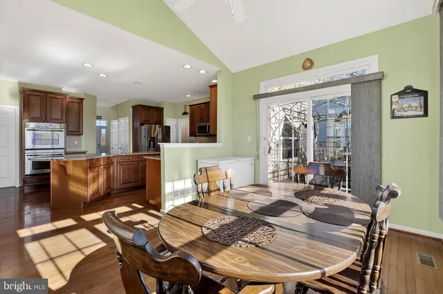 a bedroom with a bed and a dresser with mirror