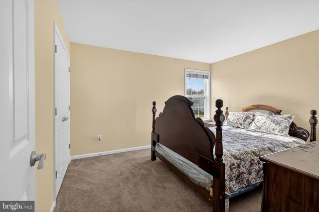 a bathroom with a shower curtain a sink a toilet and a mirror