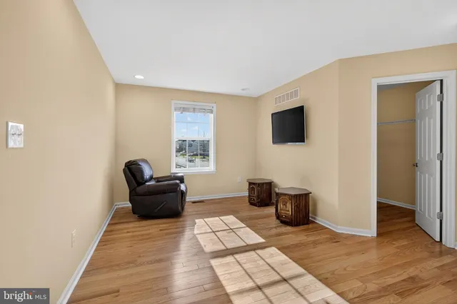 a view of a roof deck with table and chairs with wooden floor and fence