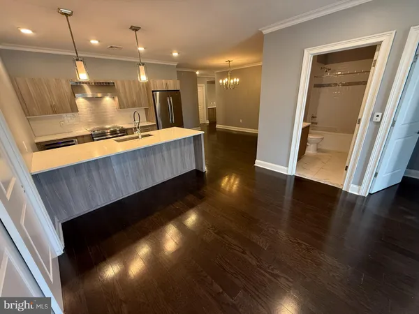a bathroom with a sink a large mirror and vanity