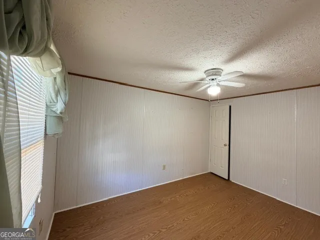 an empty room with a empty space and windows