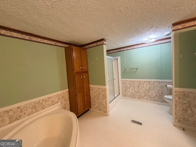 a bathroom with a bathtub a sink and a mirror