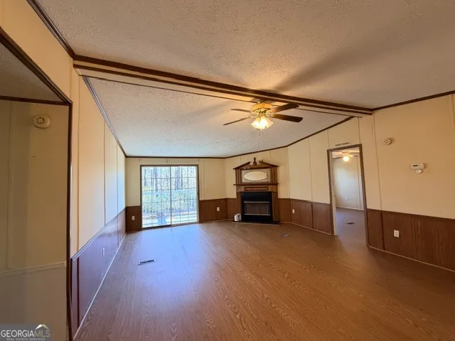 an empty room with windows and cabinet