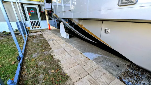 a view of a backyard with wooden fence
