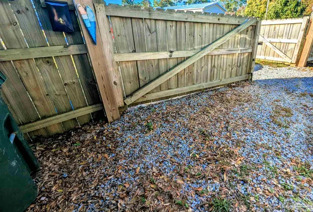 an aerial view of a house with a yard and lake view