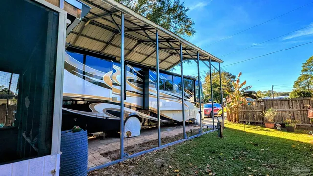 a view of patio with table and chairs and potted plants