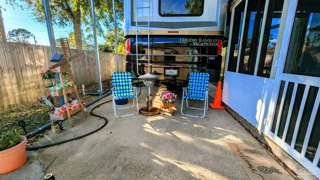a backyard of a house with table and chairs
