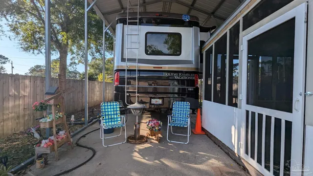 a backyard of a house with barbeque oven table and chairs