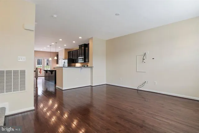 a view of a kitchen with wooden floor