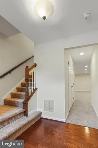 a view of entryway and hall with wooden floor