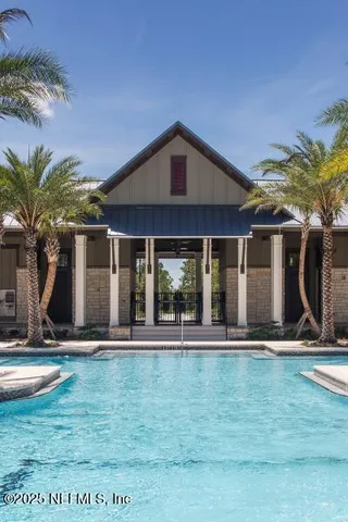 an aerial view of a house with a swimming pool