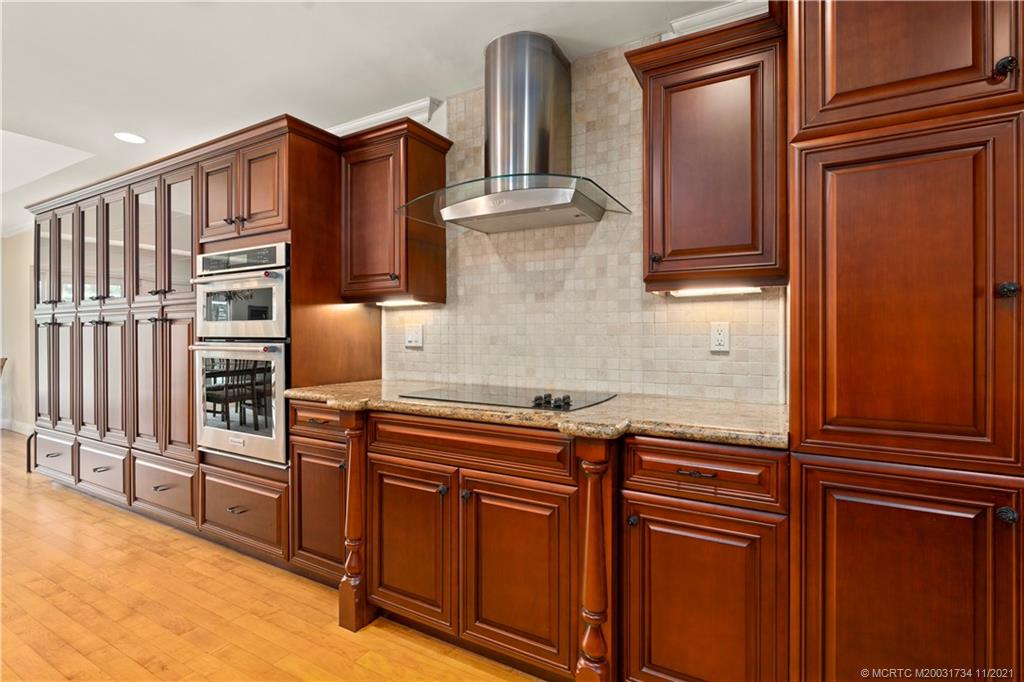 1996 Northwest Fork Road Stuart, FL 34994 - Photo 14 of 59 a kitchen with stainless steel appliances granite countertop a refrigerator and cabinets