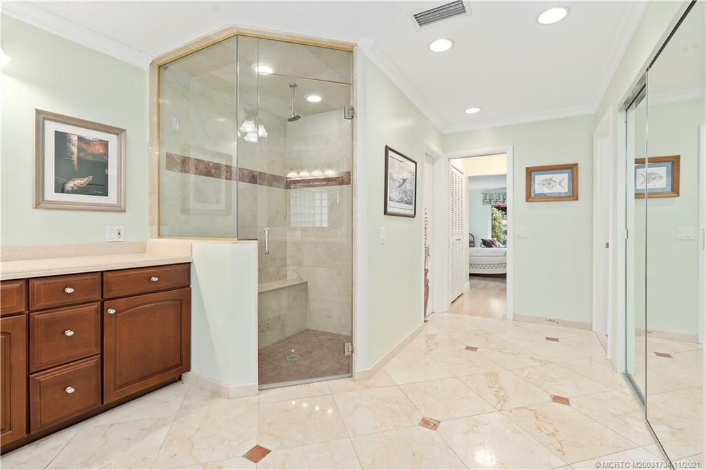 1996 Northwest Fork Road Stuart, FL 34994 - Photo 29 of 59 a spacious bathroom with a shower sink and mirror