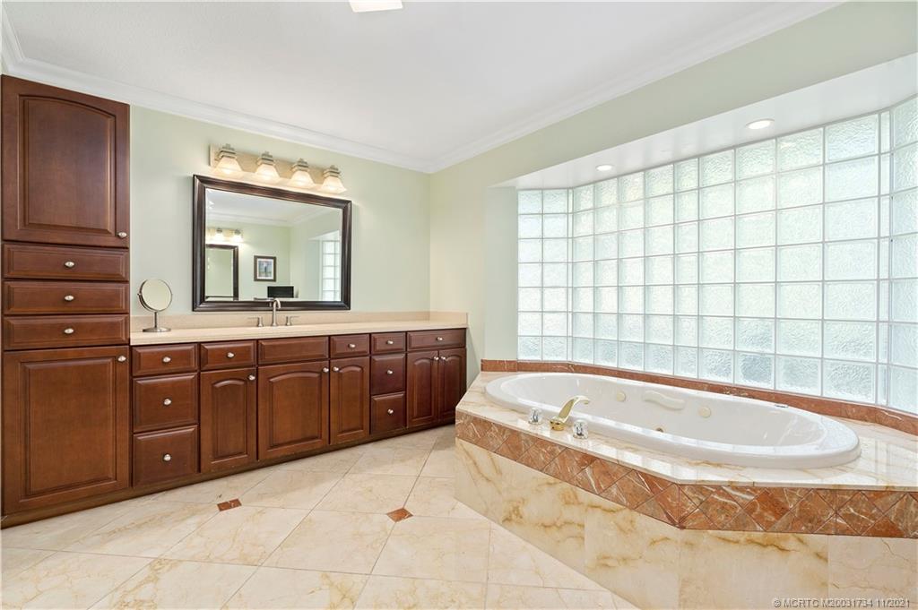 1996 Northwest Fork Road Stuart, FL 34994 - Photo 32 of 59 a spacious bathroom with a tub sink and mirror