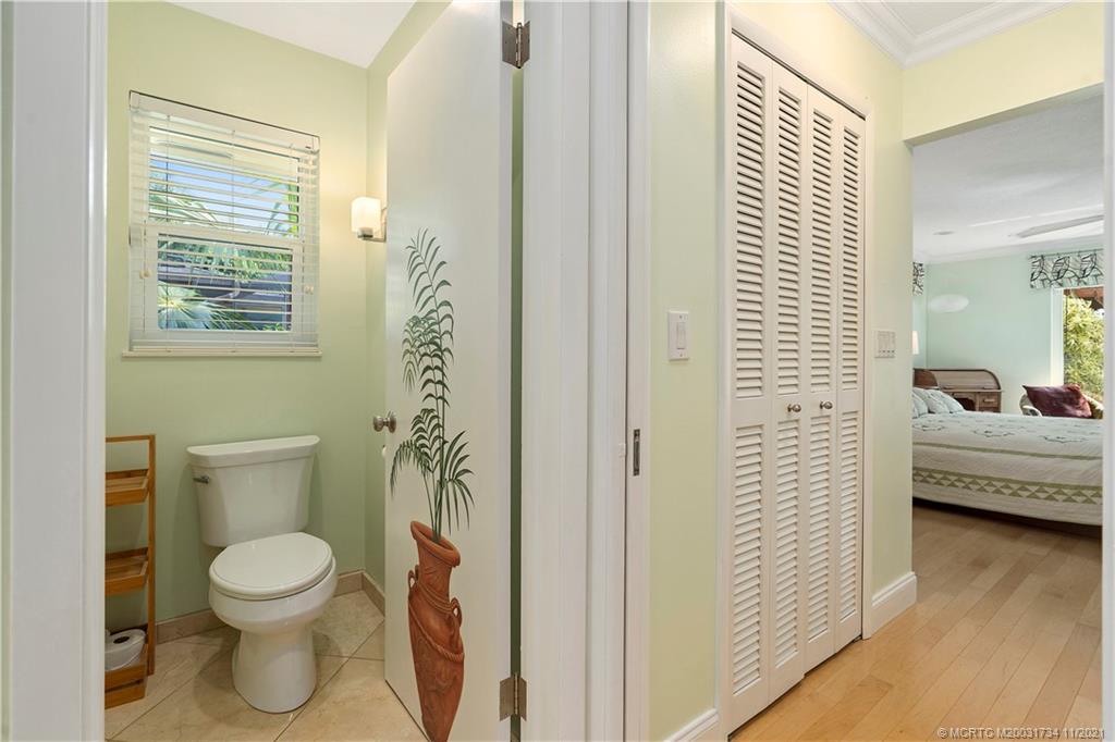 1996 Northwest Fork Road Stuart, FL 34994 - Photo 33 of 59 a bathroom with a toilet a sink and a window