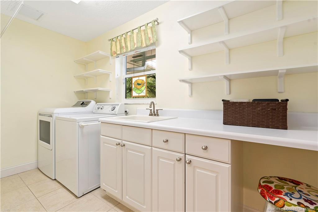 1996 Northwest Fork Road Stuart, FL 34994 - Photo 41 of 59 a bathroom with a sink and a mirror