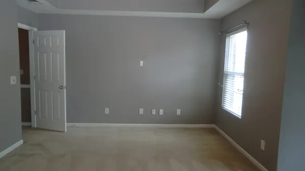 an empty room with windows and closet