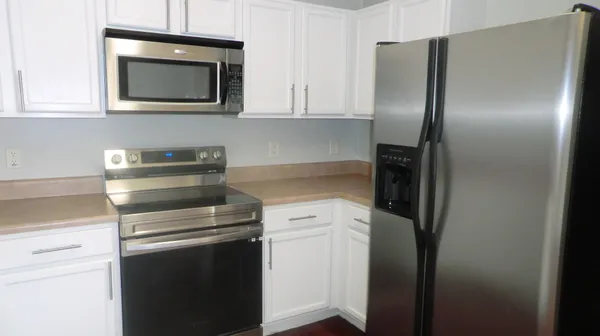 a kitchen with a stove microwave and refrigerator