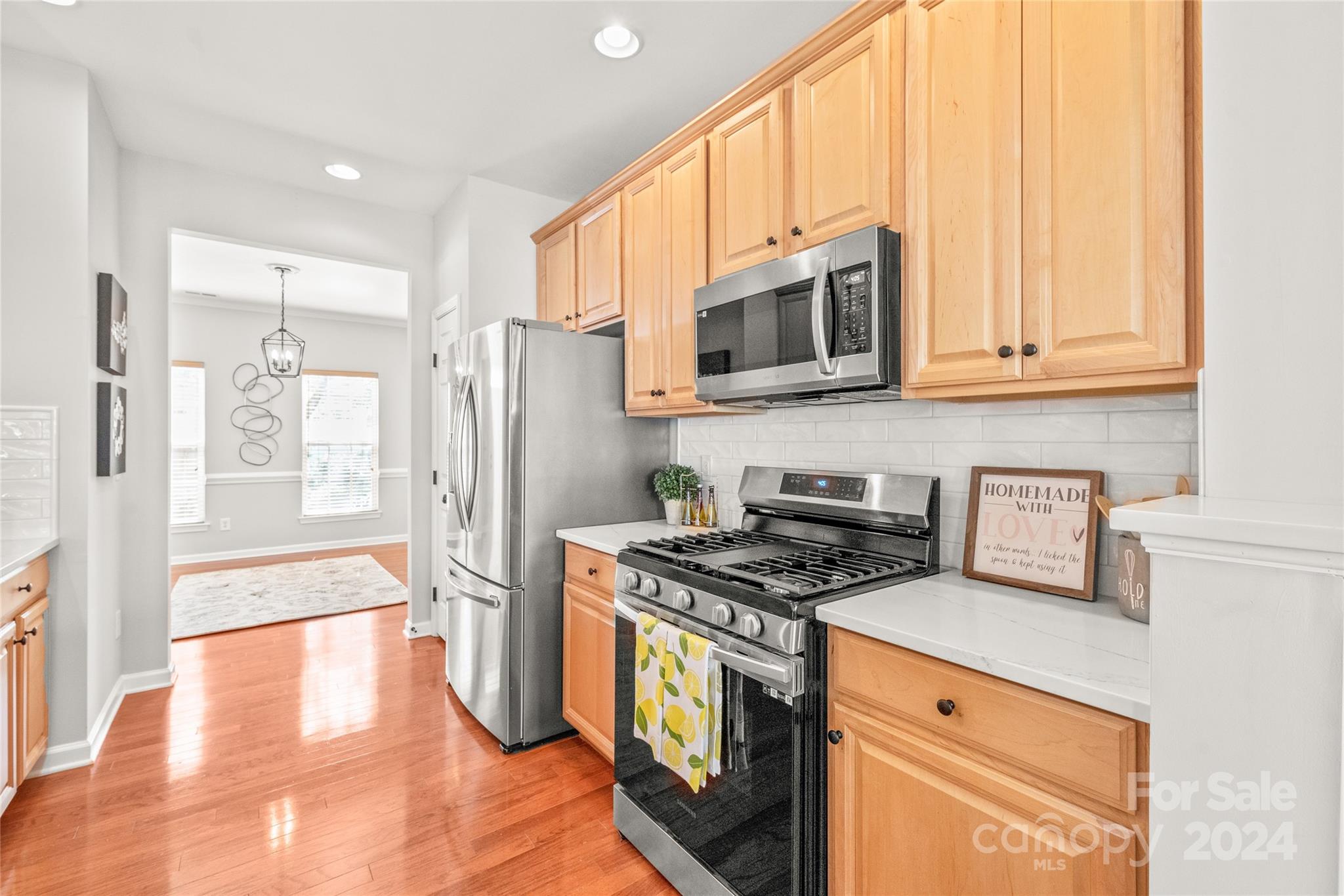 205 Snead Road Fort Mill, SC 29715 - Photo 6 of 33 a kitchen with stainless steel appliances granite countertop a stove a refrigerator and a microwave