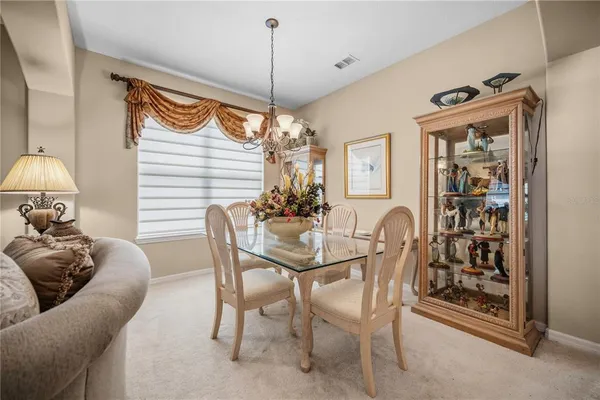 a dining room with furniture and window