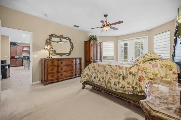 a bedroom with a bed and a chandelier