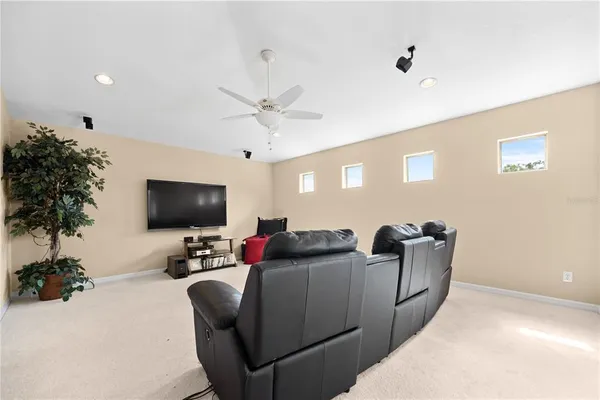 a living room with furniture and a ceiling fan