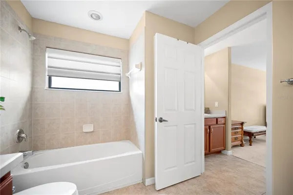 a en suite bathroom with a double vanity sink a mirror and a bathtub