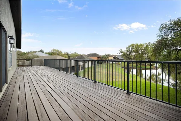 a balcony with wooden floor and fence