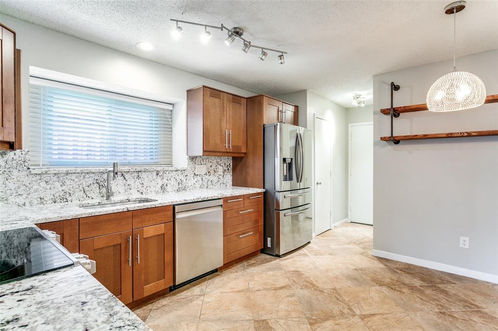 200 Lark Lane Euless, TX 76039 - Photo 12 of 25 a kitchen with stainless steel appliances granite countertop a refrigerator and a sink