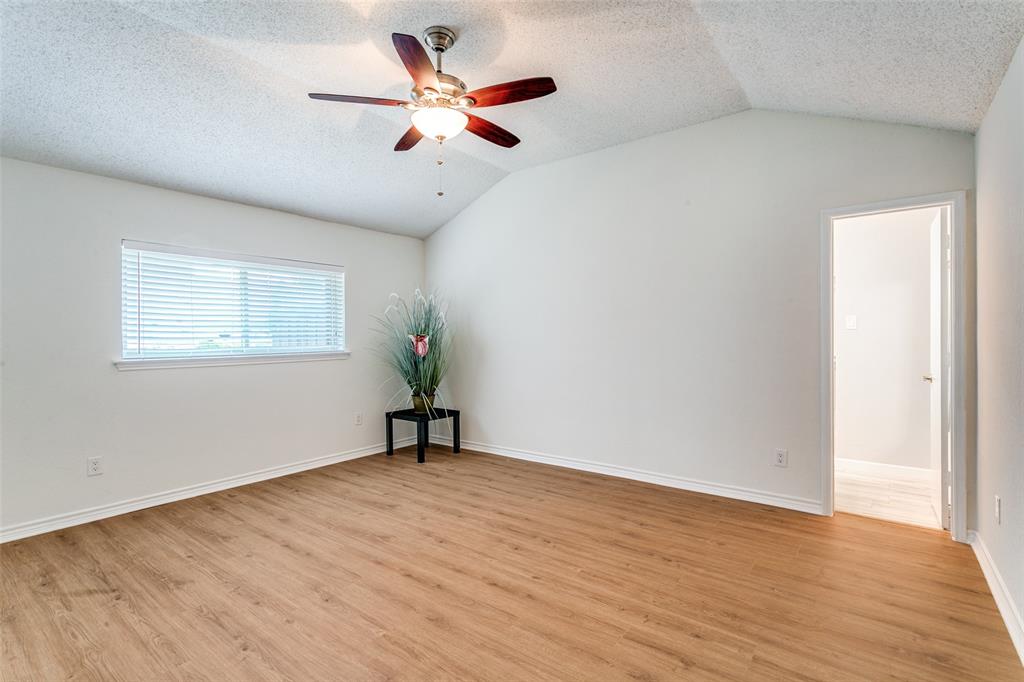 200 Lark Lane Euless, TX 76039 - Photo 14 of 25 an empty room with wooden floor and windows