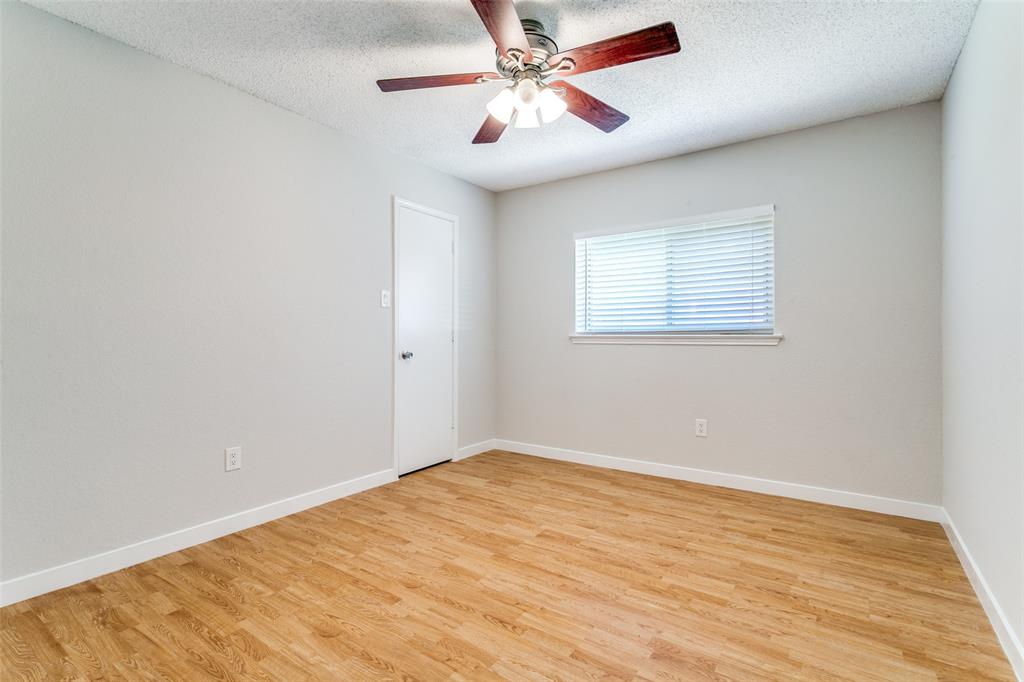200 Lark Lane Euless, TX 76039 - Photo 19 of 25 wooden floor in an empty room with a window